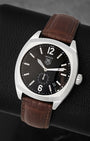 Three-quarter view of TAG Heuer Monza WR2110 showing the cushion case, black dial with small seconds, and brown strap