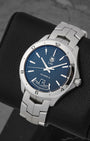 high-angle portrait of the 42mm stainless steel Link case showcasing the flat satin-brushed fixed bezel engraved with Arabic numerals