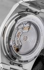 The open sapphire crystal exhibition caseback of a Tissot PRX watch revealing the automatic movement rotor