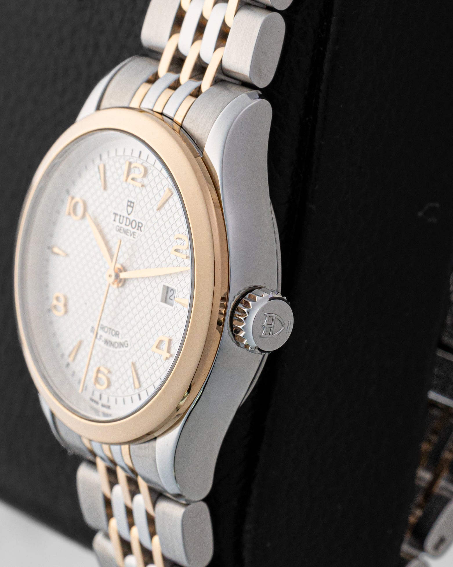 Right side profile view of the pre-owned 2024 Tudor 1926 M91351 polished steel case, smooth rose gold bezel, and steel screw-down crown with Tudor shield logo.