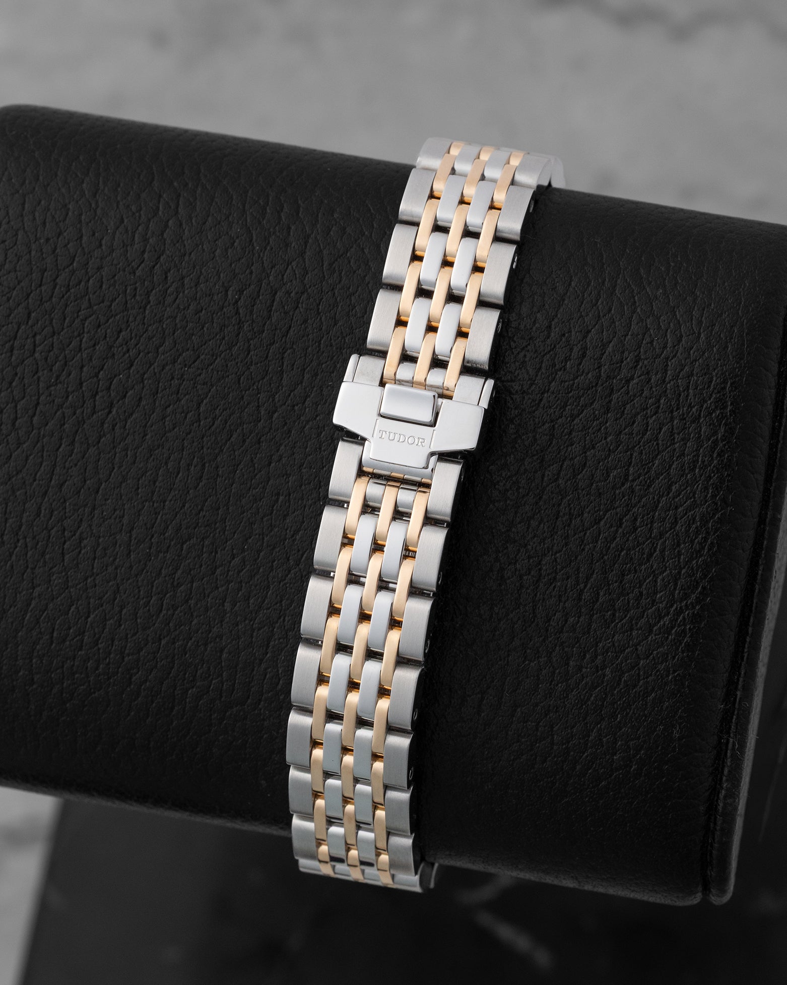 Steel and rose gold bracelet with folding safety clasp displayed on a black cushion for the pre-owned 2024 Tudor 1926 reference M91351.