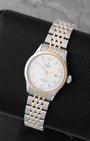Angled shot of a pre-owned 2024 Tudor 1926 reference M91351 showing the silver textured dial, rose gold smooth bezel, and two-tone steel and rose gold multi-link bracelet.