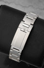 rear snapshot focusing on the brushed stainless steel rivet bracelet and the smooth T-fit micro-adjustment safety clasp