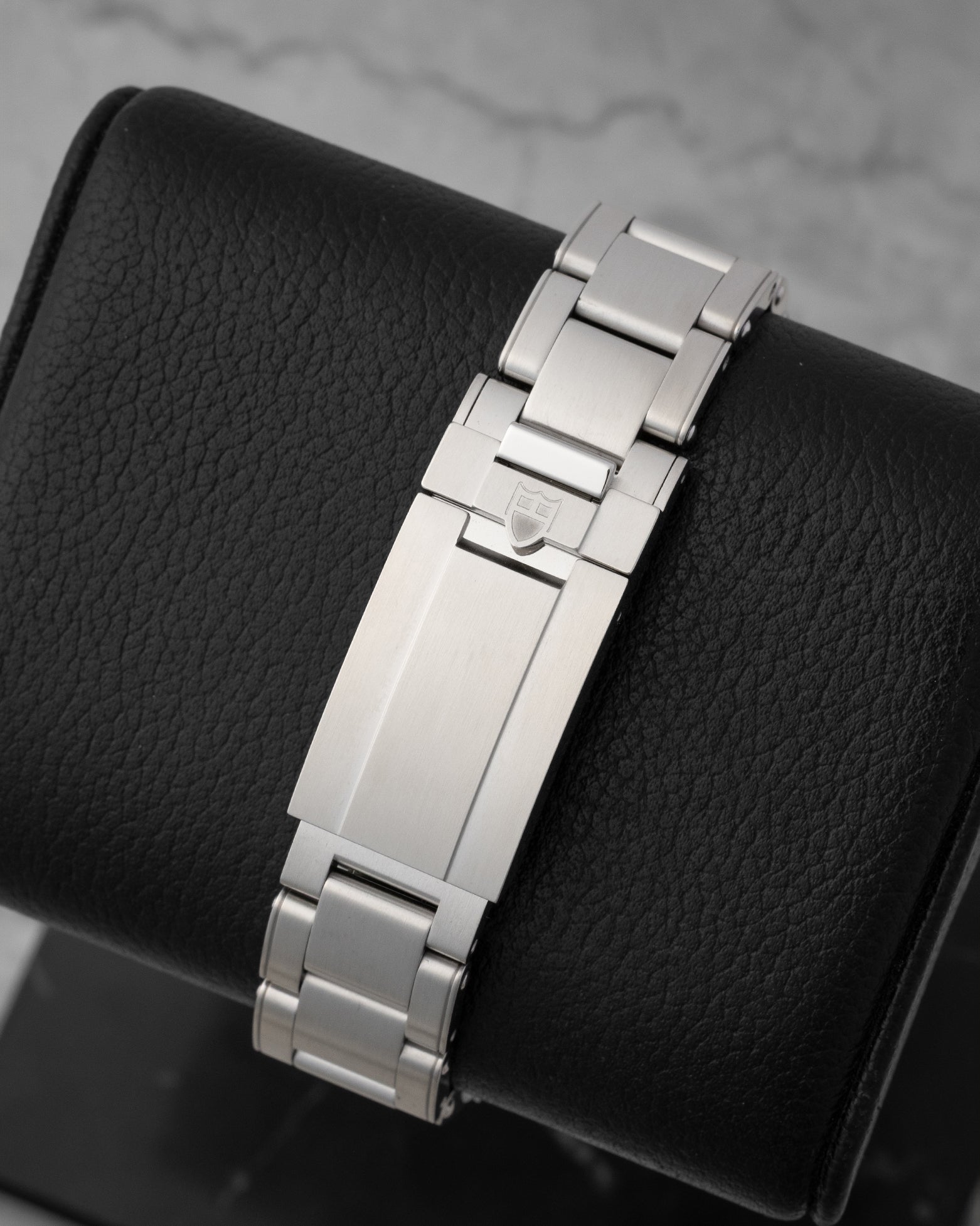 rear snapshot focusing on the brushed stainless steel rivet bracelet and the smooth T-fit micro-adjustment safety clasp