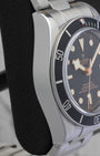 Left side profile view highlighting the polished and brushed steel case edges of the Tudor Black Bay M79230N