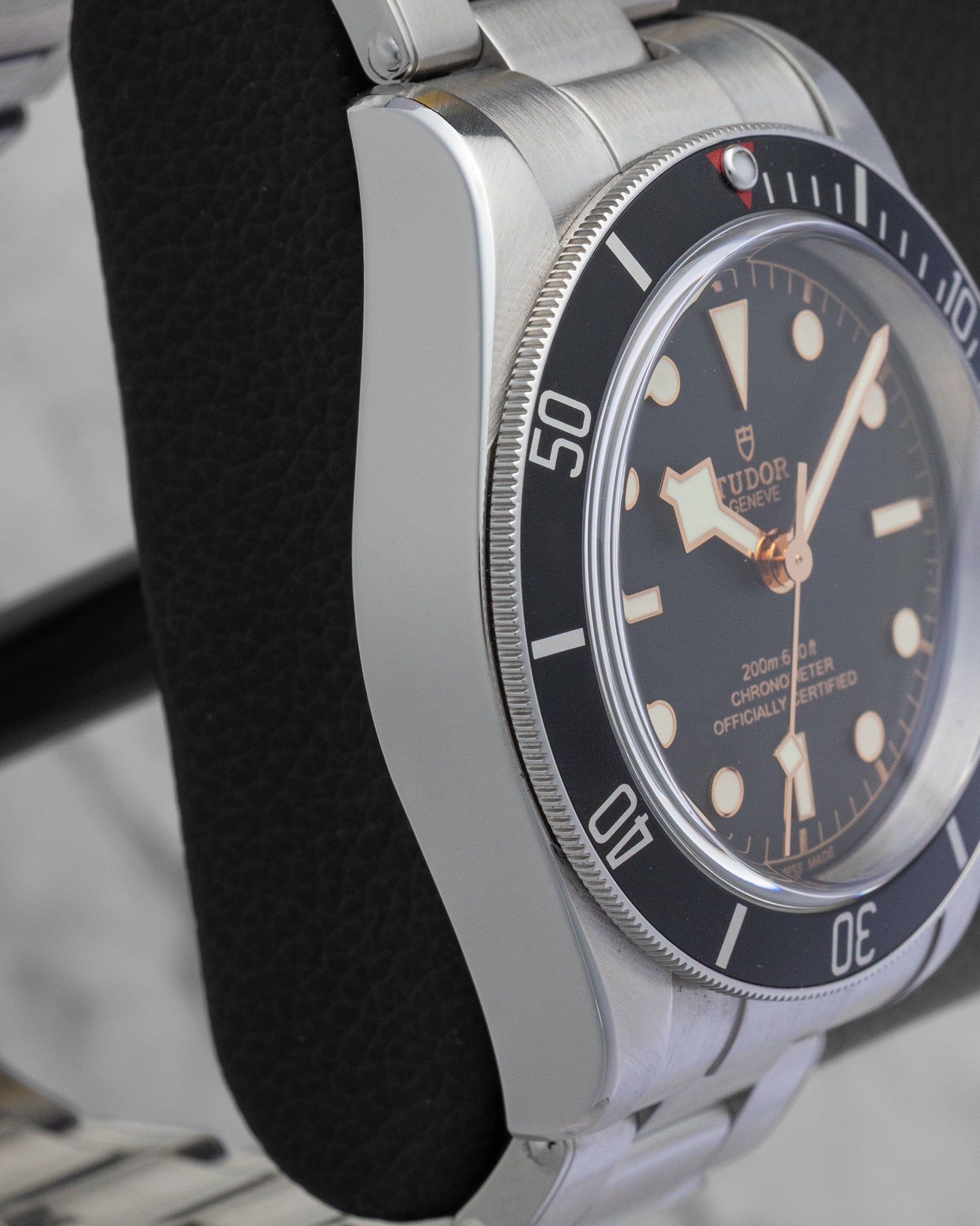 Left side profile view highlighting the polished and brushed steel case edges of the Tudor Black Bay M79230N