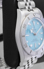 left-side case profile view of a 37mm stainless steel Tudor Black Bay 54 "Daring Watches" edition resting on a presentation block
