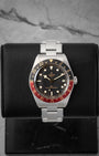studio front portrait of the 39mm Tudor Black Bay 58 GMT 7939G watch featuring its black and burgundy bezel on a leather stand