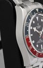 Left-side macro profile view showcasing the characteristic high-polished slab caseband wall and the clean integrated sweep of the steel faux-rivet style link bracelet