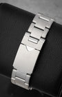 rear snapshot focusing on the brushed stainless steel three-link rivet-style bracelet and the folding safety clasp closure
