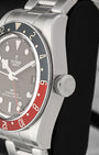 Close-up right profile view of the watch head focusing on the coin-edge bezel grip, domed sapphire crystal, and the prominent oversized screw-down winding crown engraved with the Tudor rose