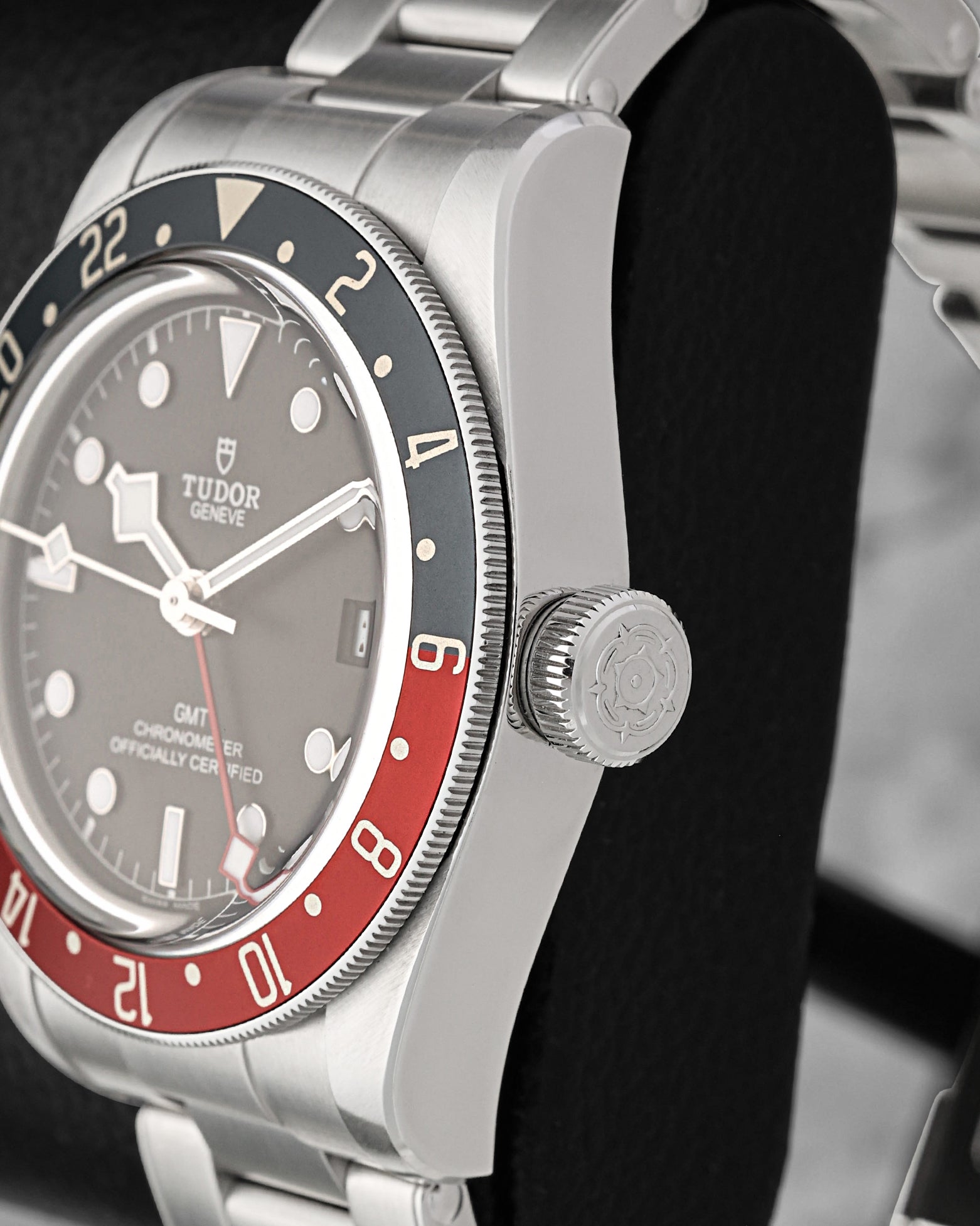 Close-up right profile view of the watch head focusing on the coin-edge bezel grip, domed sapphire crystal, and the prominent oversized screw-down winding crown engraved with the Tudor rose