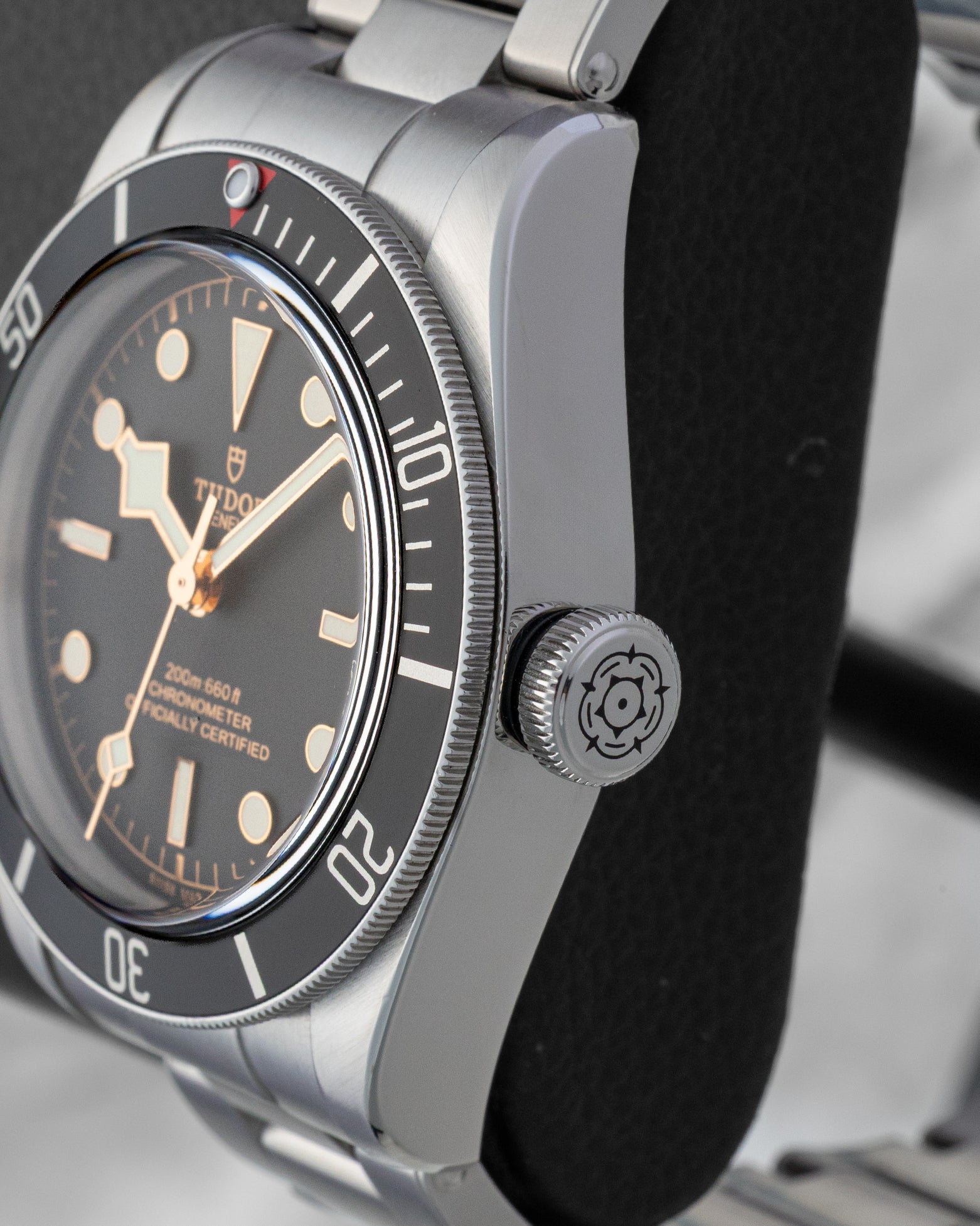Close-up of the large winding crown and brushed steel case profile on a Tudor Black Bay 41mm watch