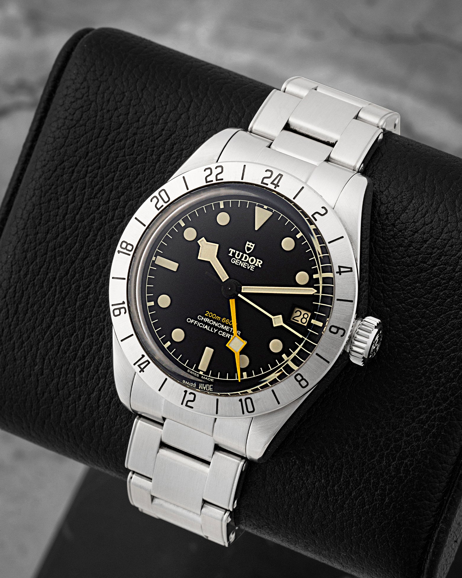 Angled view of pre-owned Tudor Black Bay Pro 79470 featuring a matte black domed dial, luminous hour markers, and fixed 24-hour graduated steel bezel