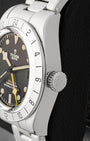 Side profile view showing the stainless steel screw-down winding crown engraved with the Tudor rose on Black Bay Pro 79470