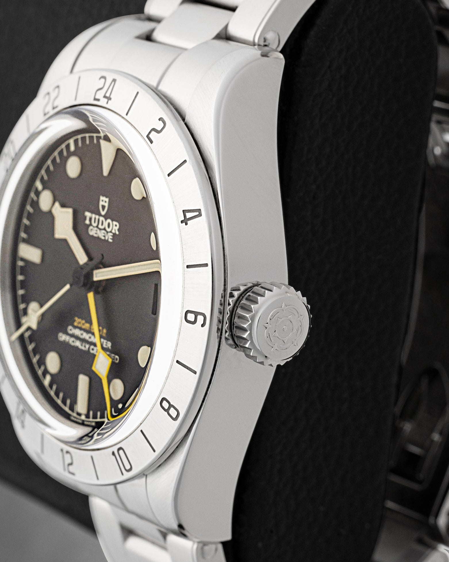 Side profile view showing the stainless steel screw-down winding crown engraved with the Tudor rose on Black Bay Pro 79470