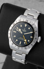Angled view of Tudor Black Bay Pro 79470 showing matte black dial, yellow GMT hand, ceramic hour markers, and fixed 24-hour bezel