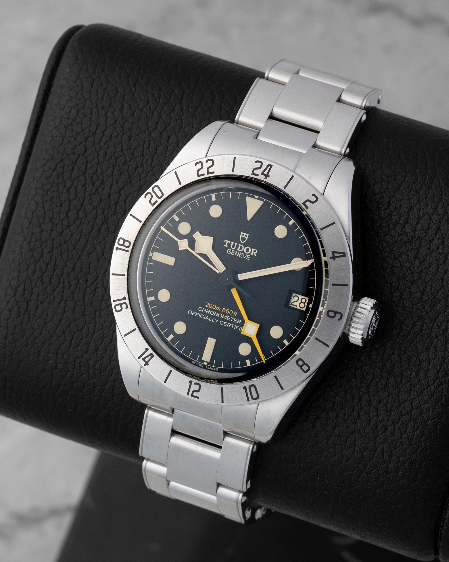 Angled view of Tudor Black Bay Pro 79470 showing matte black dial, yellow GMT hand, ceramic hour markers, and fixed 24-hour bezel