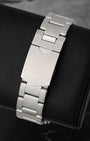 A rear view of the three-row stainless steel oyster link bracelet focusing on the secure closure of the satin-brushed folding deployment buckle detailed with a polished Tudor shield safety latch