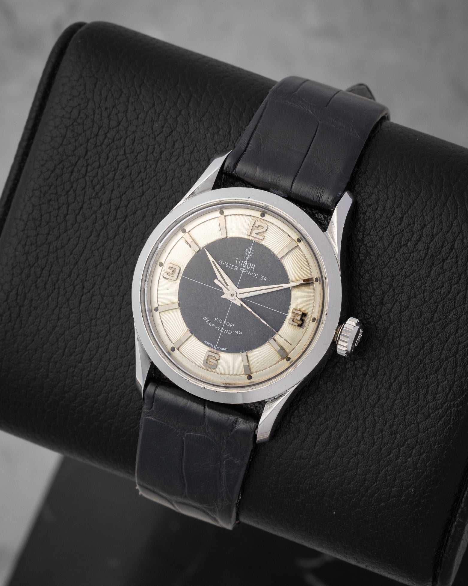 angled top-down overview of the 34mm vintage stainless steel Tudor Oyster Prince reference 7950 showing its cross-hair Tuxedo dial configuration
