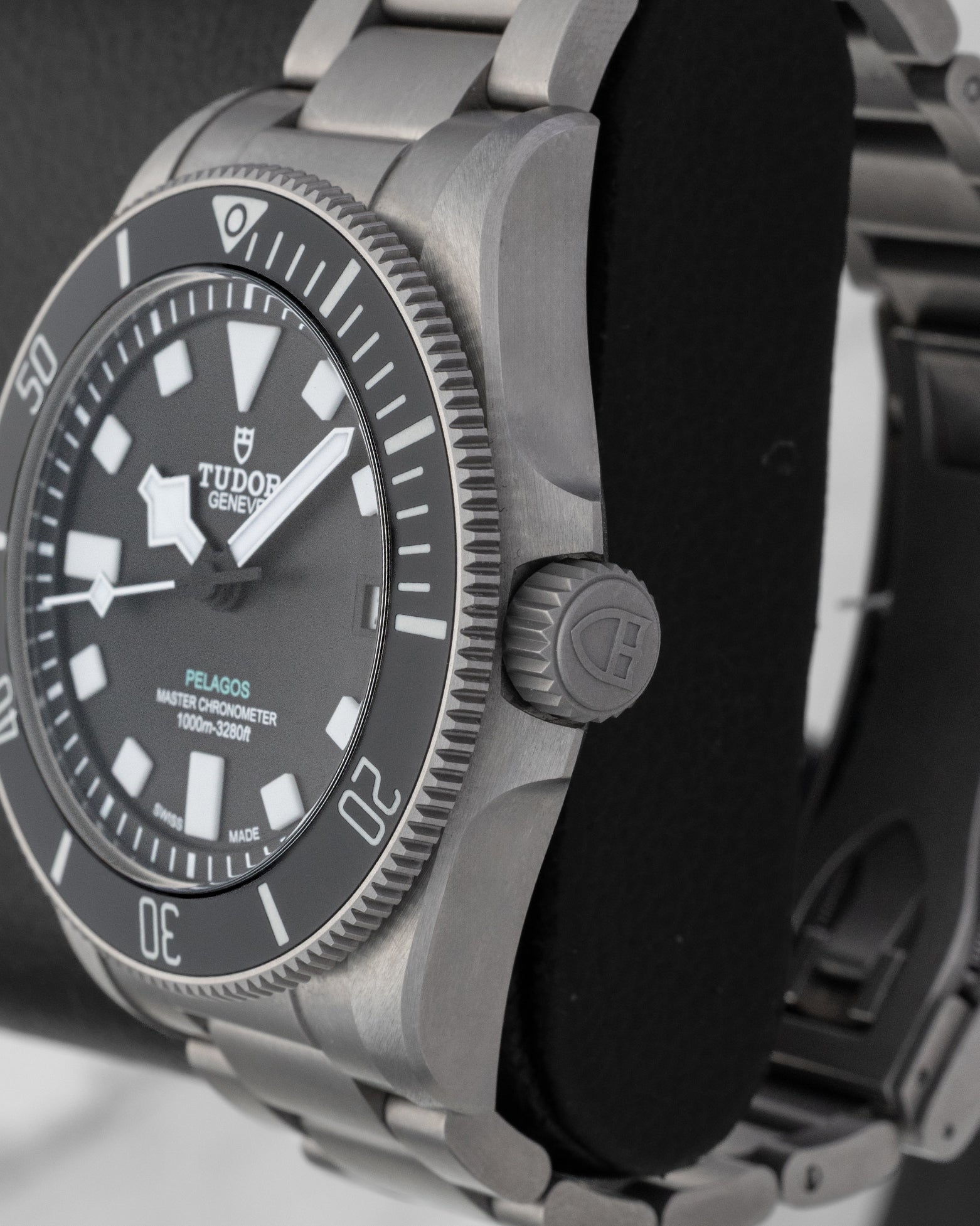 Right side profile showcasing the titanium screw-down crown and matte black ceramic unidirectional rotating bezel on a Tudor Pelagos Ultra
