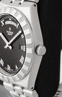 Side profile view displaying the notched stainless steel bezel and screw-down winding crown engraved with the Tudor logo on Tudor Royal M28600