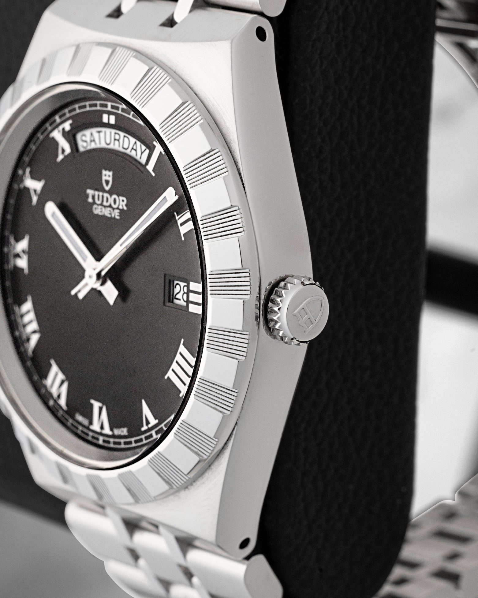 Side profile view displaying the notched stainless steel bezel and screw-down winding crown engraved with the Tudor logo on Tudor Royal M28600