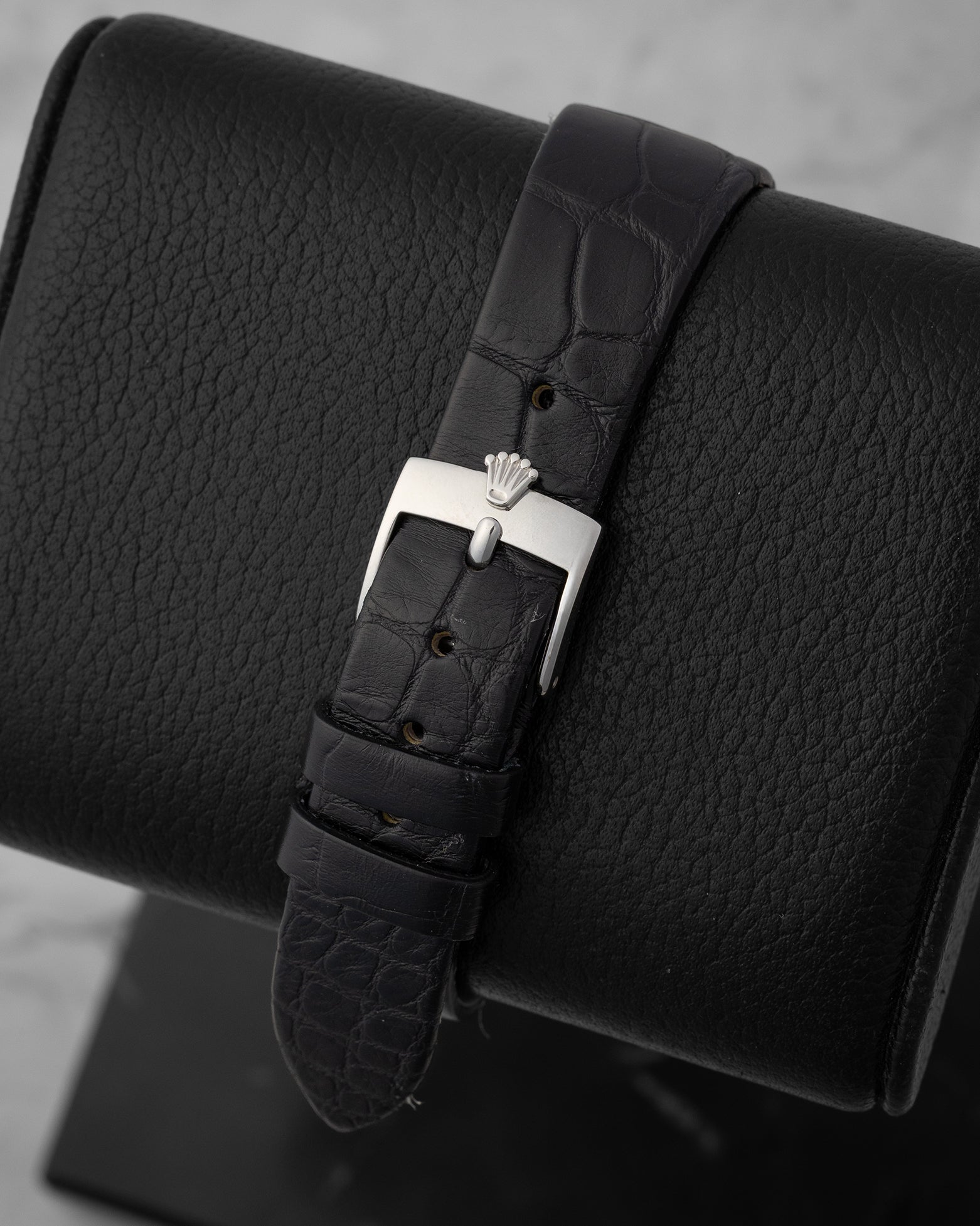 rear snapshot focusing on the black scaled alligator leather strap and the vintage-style polished stainless steel pin buckle