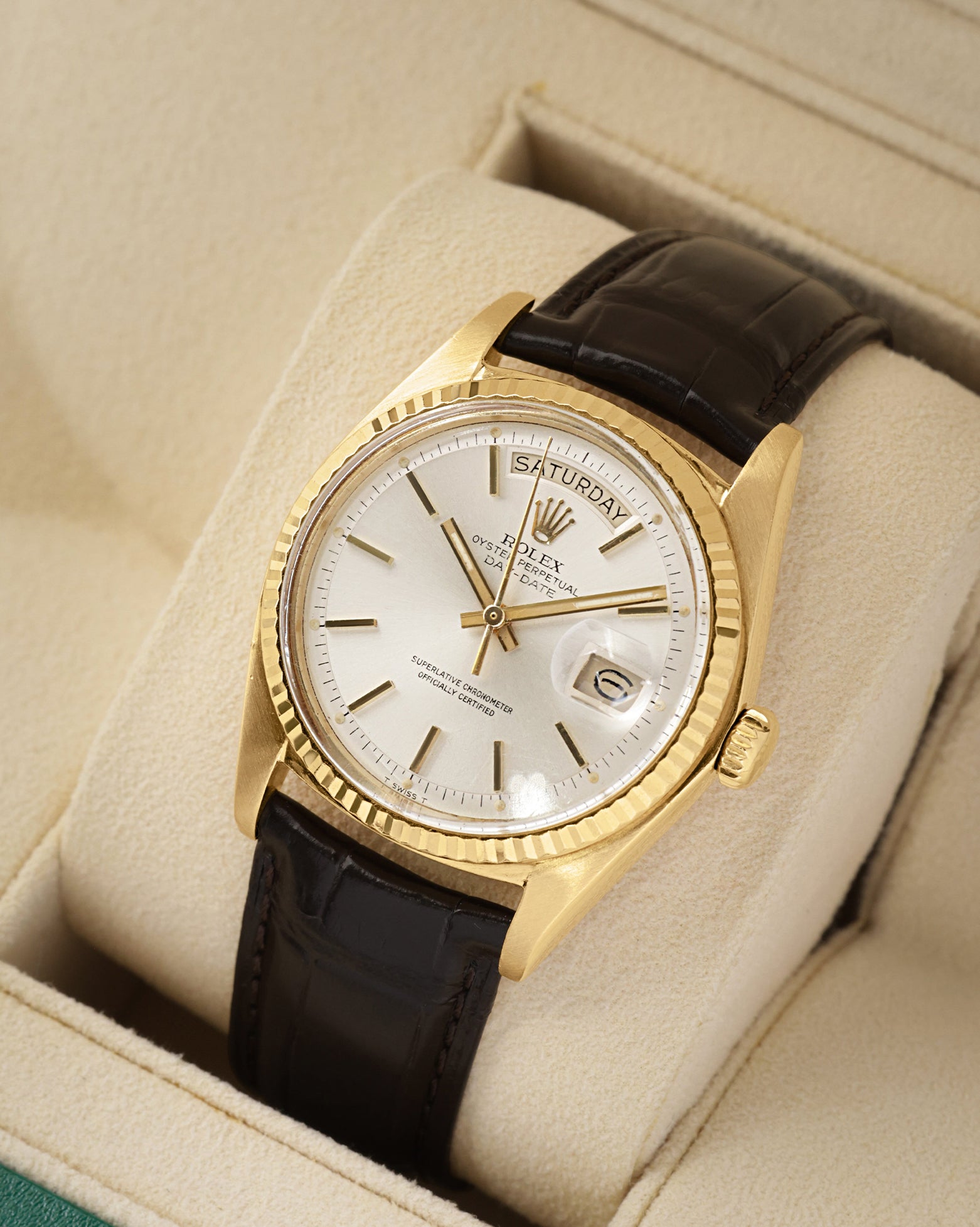 angled view of a vintage 1973 Rolex Day-Date President watch showcasing the distinctive recessed outer edge pie-pan dial and custom brown leather strap