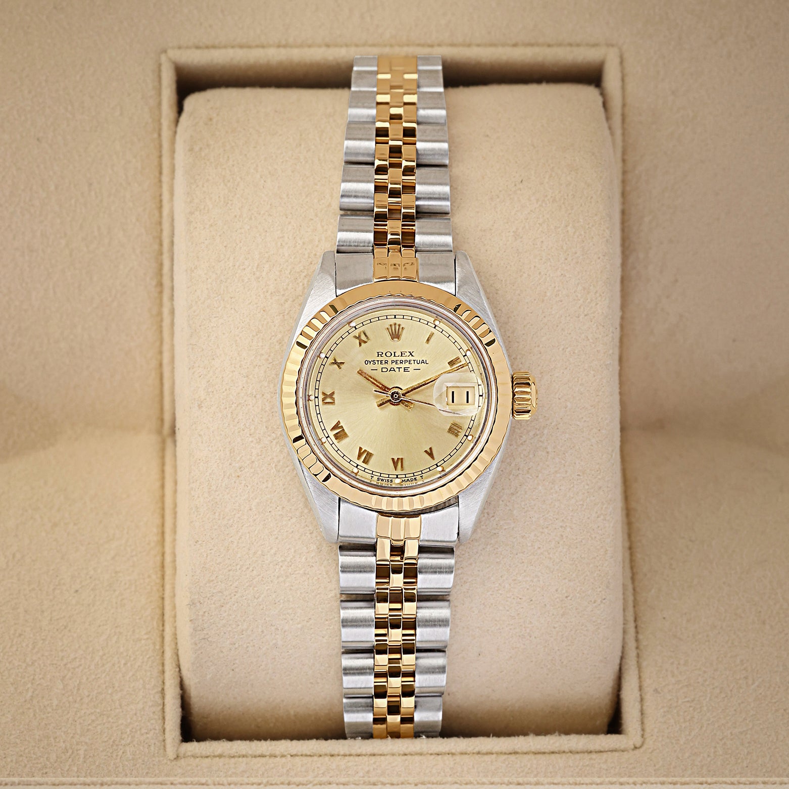 A ladies' vintage 1981 Rolex Lady-Datejust reference 6916 in two-tone 14k gold and steel featuring a champagne dial with printed Roman numeral markers inside its box at Noah's Fine Watches & Jewelry in Dallas