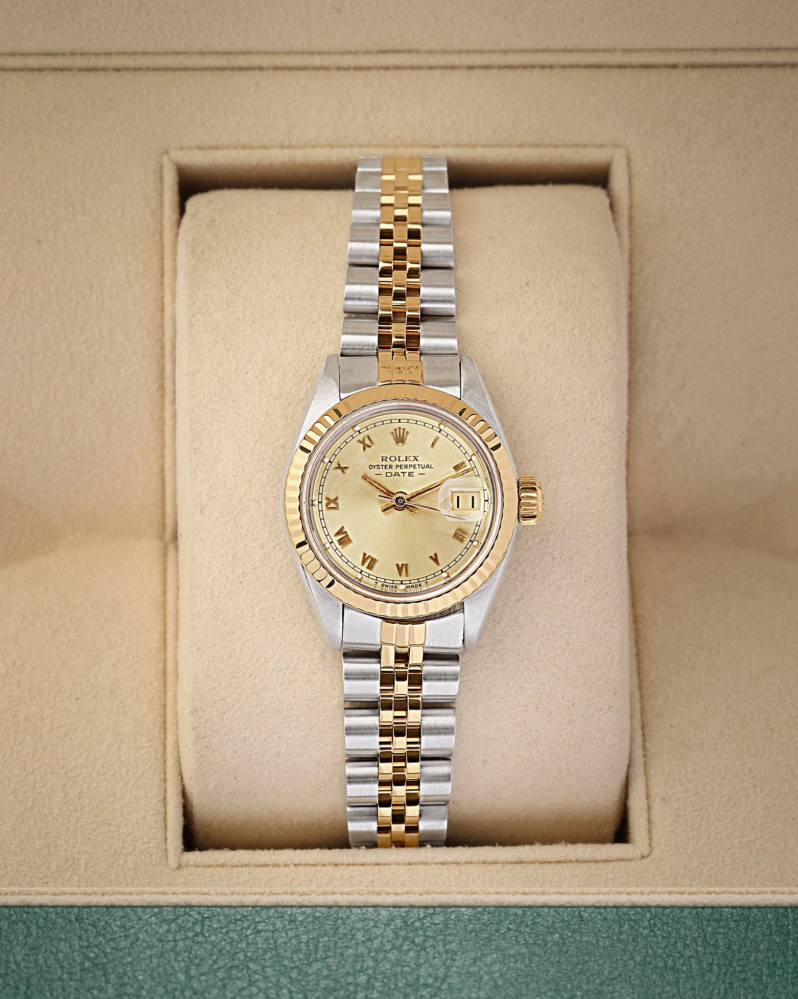 A ladies' vintage 1981 Rolex Lady-Datejust reference 6916 in two-tone 14k gold and steel featuring a champagne dial with printed Roman numeral markers inside its box at Noah's Fine Watches & Jewelry in Dallas