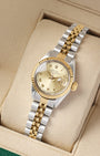 A high-angle three-quarter portrait of the 26mm two-tone luxury watch case showcasing its 14k yellow gold fluted bezel upgrade and matching steel and gold Jubilee links