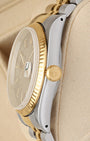 Close-up right profile view of the 36mm watch head highlighting the flat scratch-resistant sapphire crystal with magnified Cyclops lens and the fluted yellow gold winding crown