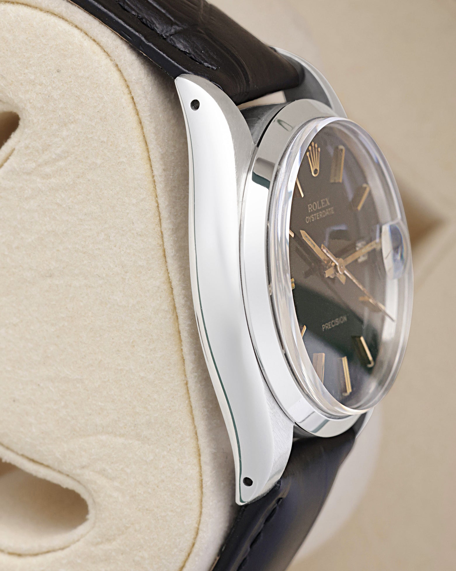Side profile view of the polished stainless steel case on the non-crown side of a vintage 34mm Rolex Oysterdate Precision