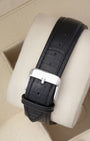 Rear view of the smooth black leather watch strap highlighting the polished stainless steel tang buckle closure