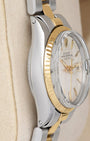 Side profile view of the polished stainless steel Oyster case on the non-crown side of a vintage 1969 Rolex Date 26mm watch