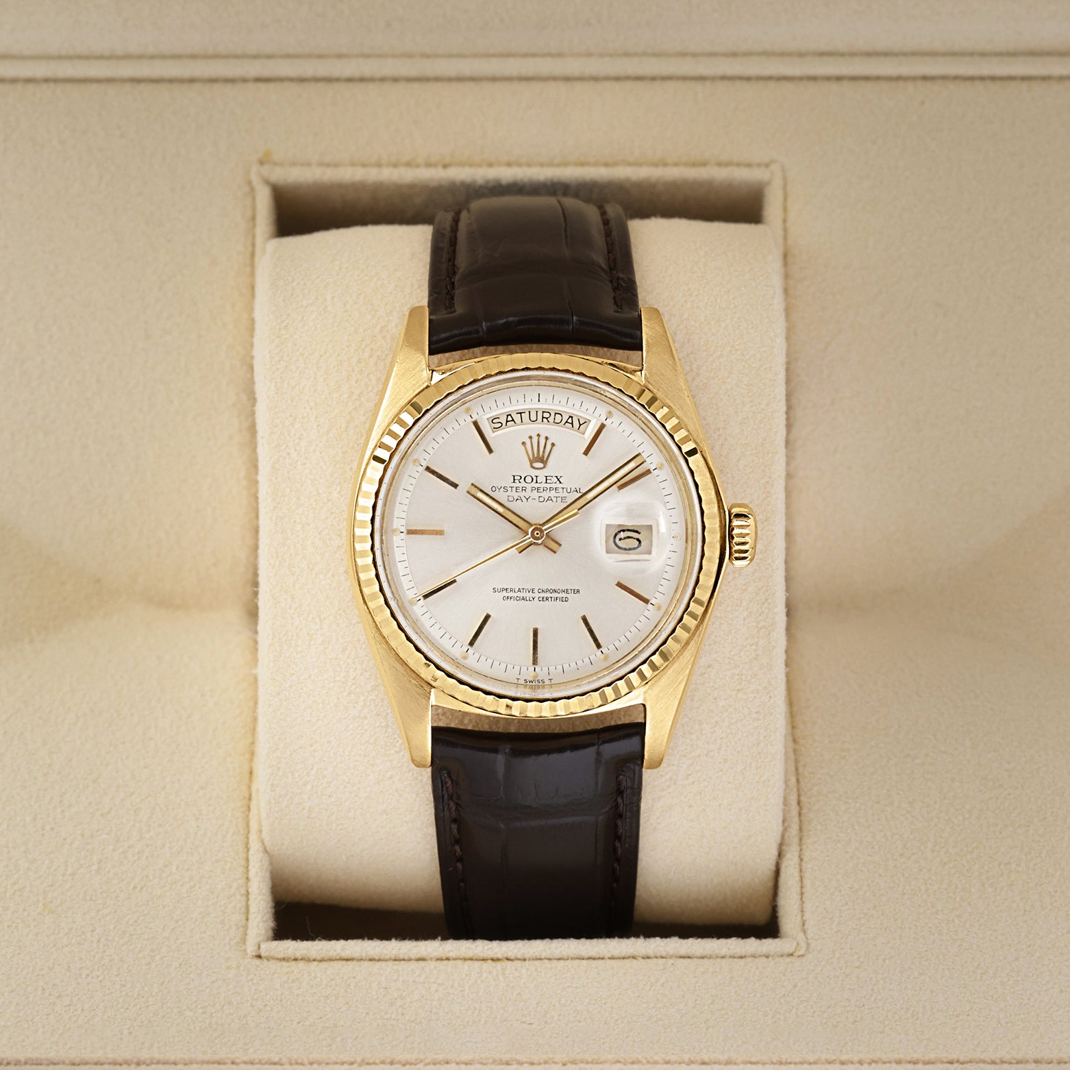 Front view of a vintage 1973 Rolex Day-Date Ref 1803 in 18k yellow gold, featuring a classic silver pie-pan dial and fluted bezel, available at Noah's Fine Watches and Jewelry Dallas