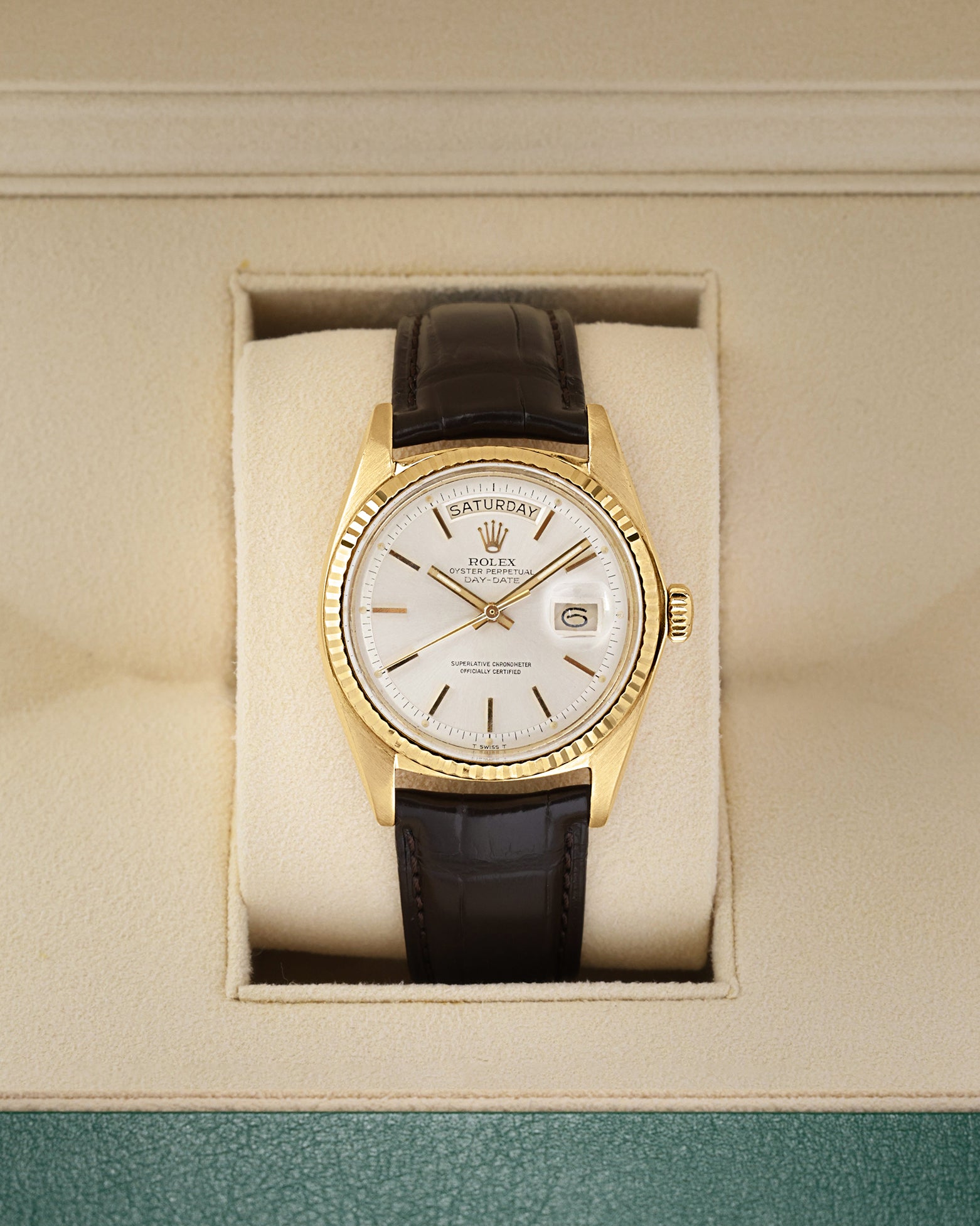 Front view of a vintage 1973 Rolex Day-Date Ref 1803 in 18k yellow gold, featuring a classic silver pie-pan dial and fluted bezel, available at Noah's Fine Watches and Jewelry Dallas