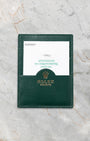 The official green Rolex pebble-grained leather document wallet displaying a factory booklet insert flat on a marble surface