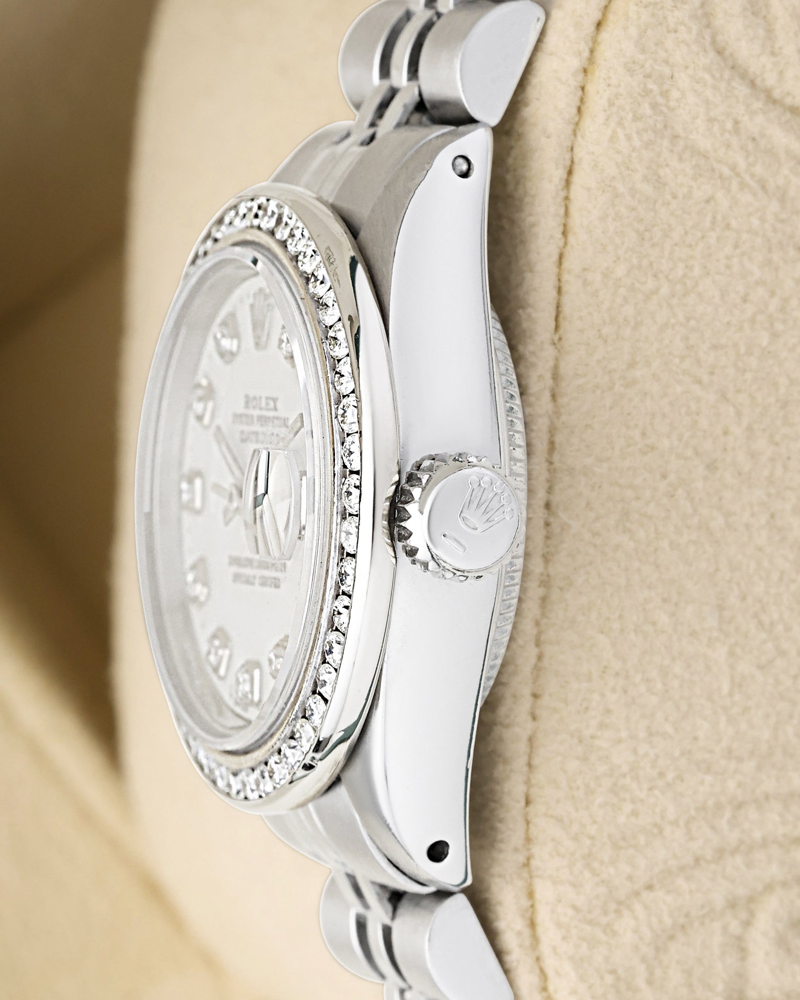 Polished stainless steel case profile view showcasing the screw-down winding crown on a vintage 26mm Rolex Lady-Datejust