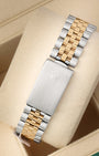 A rear view of the vintage two-tone metal watch band focusing on the secure closure of the classic stainless steel fold-over deployant clasp detailed with an embossed Rolex crown logo