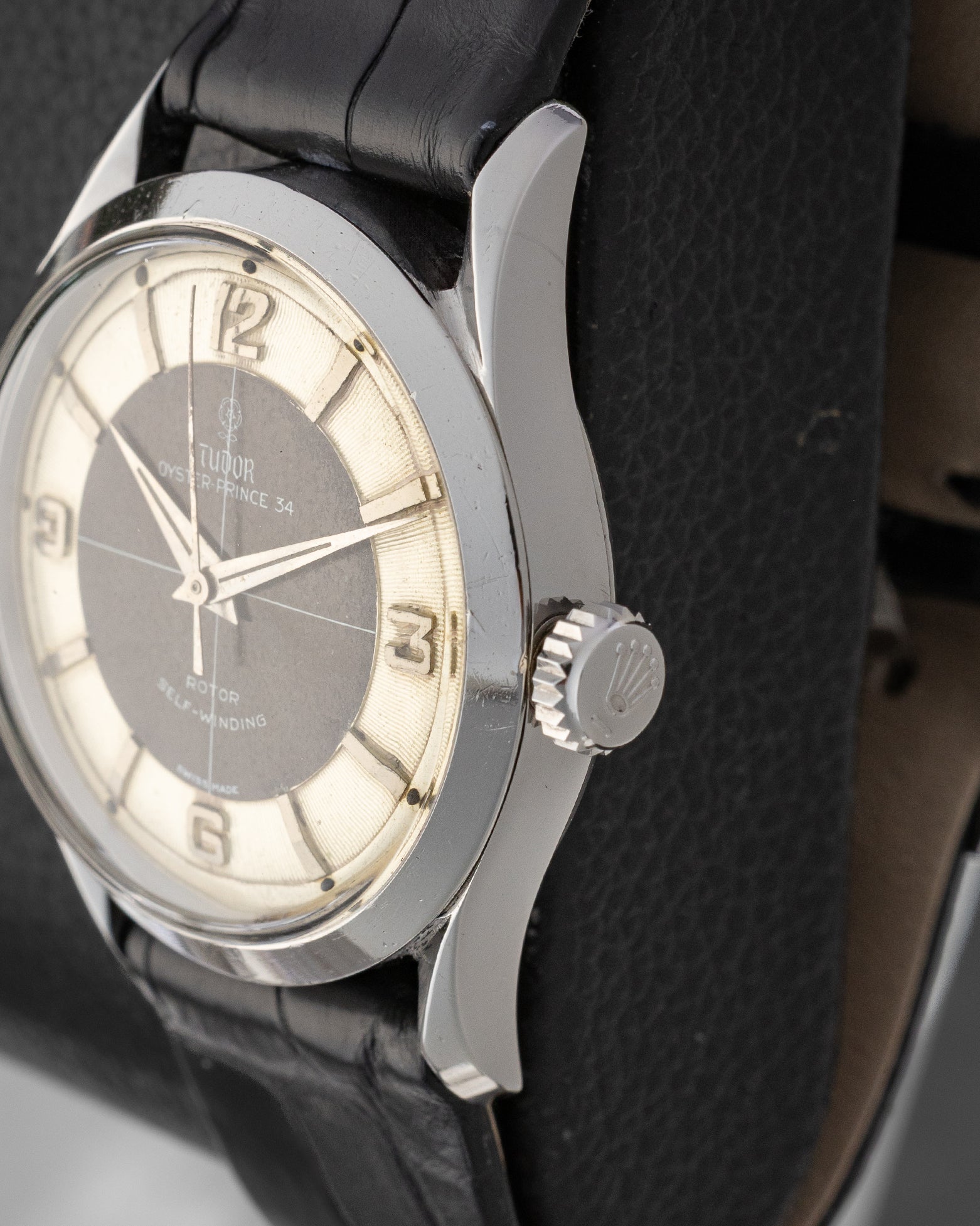 Close-up right profile view of the vintage steel Tudor 7950 case highlighting the original winding crown and smooth polished bezel